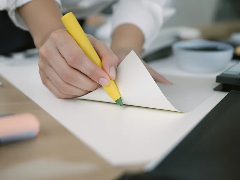 Hands reviewing a printed document at a desk