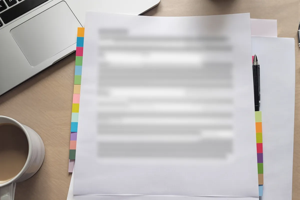 A finished report laid flat on a desk, ready to be handed over